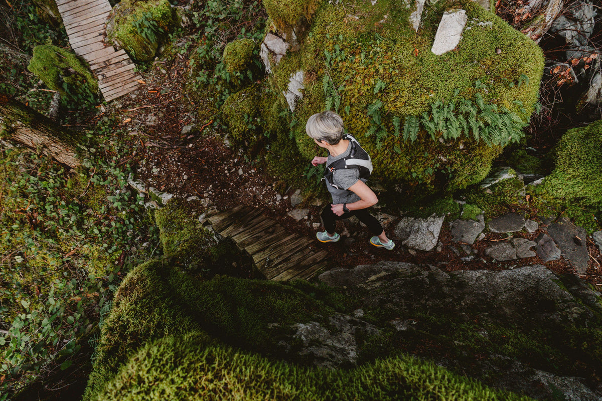 Runner on a mossy boardwalk trail