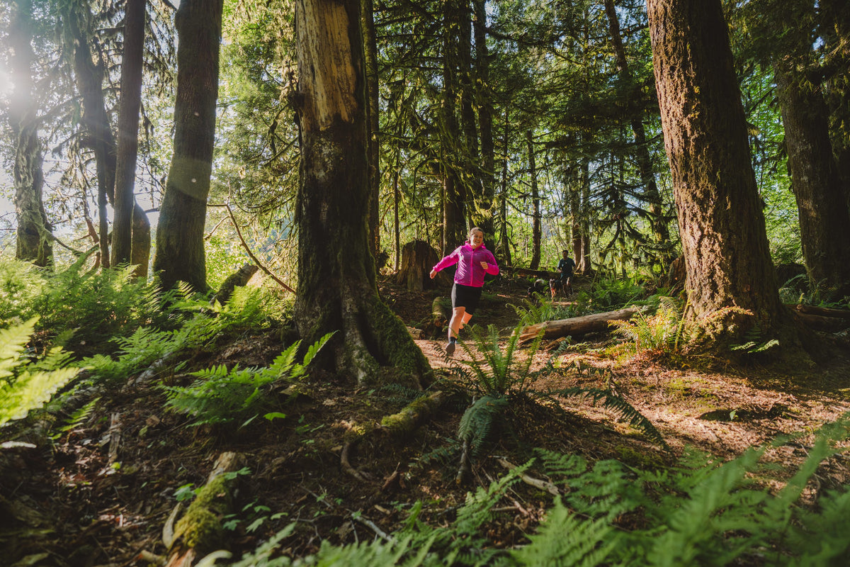 Runner in a pink top in the forest
