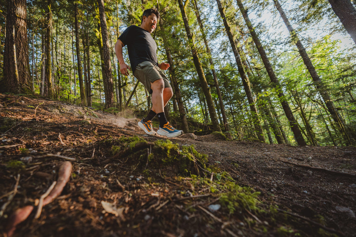 Runner descending a forest trail