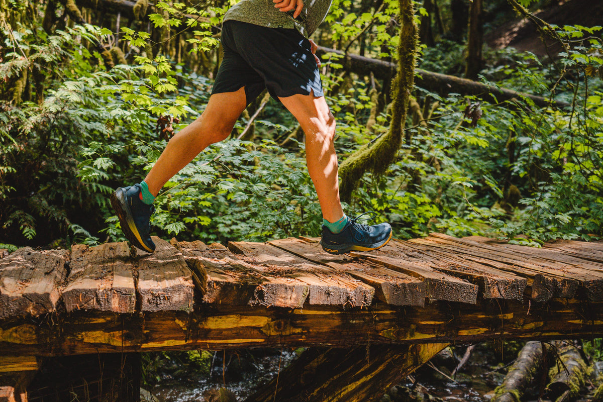 Runner crossing a wooden footbridge