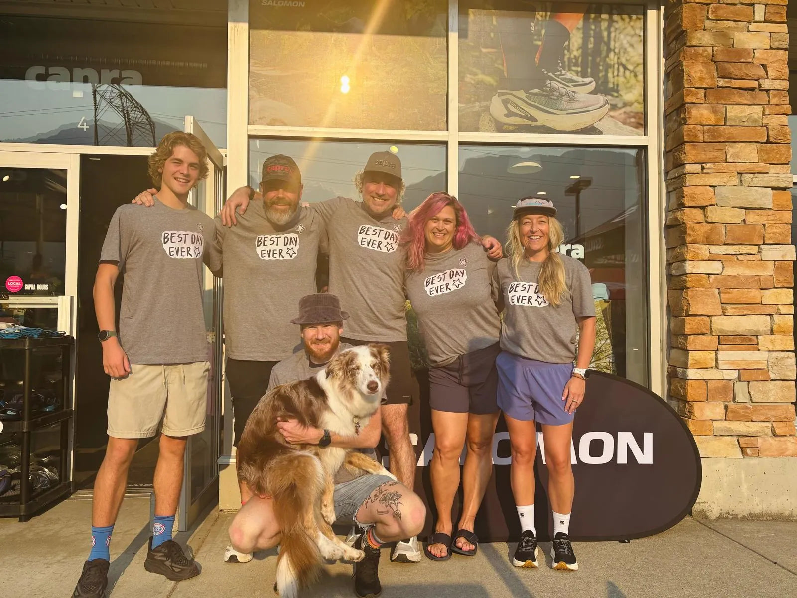 The Capra crew in Best Day Ever shirts outside the shop on Tantalus Road, with the shop dog